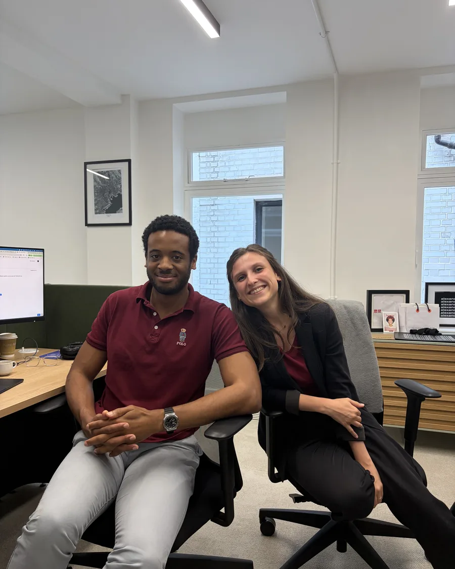 Two Teamwork Commerce team members at their desks