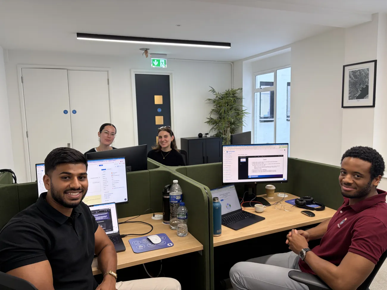 Team members working together at their desks